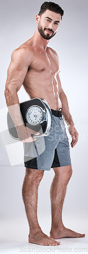 Image of Fitness, exercise or man weight scale in studio after body training or gym workout for wellness goals. Healthy, progress or motivation with a male athlete in a club to monitor exercising performance