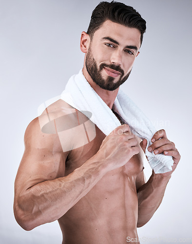 Image of Portrait, fitness or man with towel after shower, cleaning or bathing for healthy body hygiene or wellness. Topless, goals or model with six pack, abs or biceps muscles isolated on studio background