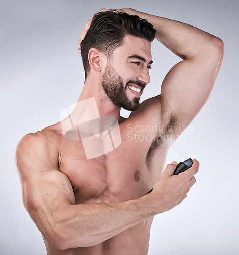 Image of Skincare, spray and man with smile, perfume and deodorant for wellness on grey studio background. Hygiene for arm pit, male and gentleman with fragrance, freshness and grooming routine on backdrop