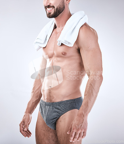 Image of Sexy, underwear and man with muscle as beauty, skincare or self care isolated in studio gray background. Model, handsome and perfect athletic body of masculine male is confident with a towel