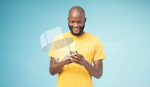 Image of Black man, phone or typing on blue background, isolated mockup or wall mock up on social media, internet app or blogging. Smile, happy person or fashion clothes on mobile technology for trendy ideas