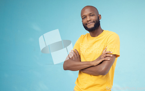 Image of Black man, portrait smile and arms crossed on mockup for advertising or marketing casual fashion. Happy African American male standing in confidence smiling for profile on a blue studio background