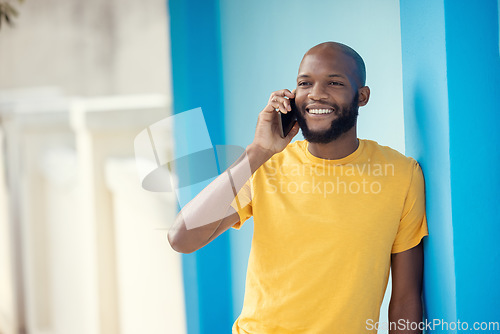 Image of Black man, fashion or phone call on blue background or city wall for talking, communication or social networking app. Smile, happy or student on mobile technology in trendy, cool or stylish clothes