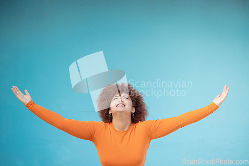 Image of Advertising, studio space and open arms of black woman for announcement, news and sale. Marketing, discount mockup and girl present, show and display copyspace for promotion on blue background