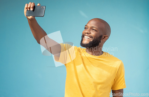 Image of Black man, happy or selfie on blue background, isolated mock up or wall mockup for social media app or vlogging. Smile, blogger or influencer on tech photography for live streaming or profile picture