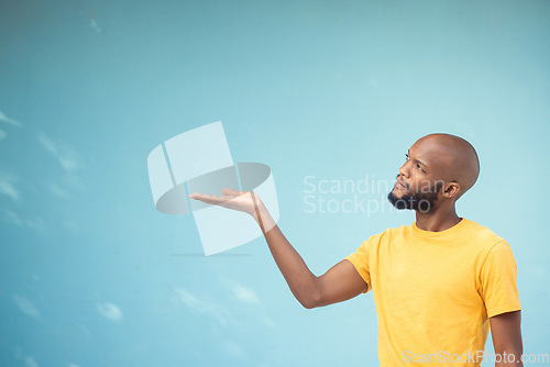 Image of Advertising, product placement and hand of black man on blue background for announcement, news and information. Marketing, thinking and male show copy space for promotion, branding and idea mockup