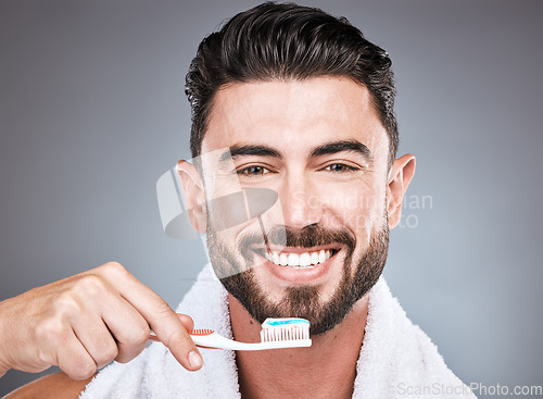 Image of Brushing teeth, studio portrait and man with toothbrush for dental wellness, healthy lifestyle or mouth care. Happy face, male model and oral cleaning of fresh breath, smile and happiness on backdrop