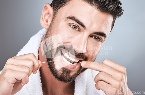 Image of Mouth floss, tooth and man in studio for wellness, healthy body care or hygiene on background. Teeth, flossing and guy with dental cleaning for facial beauty, fresh breath or happy bathroom cosmetics