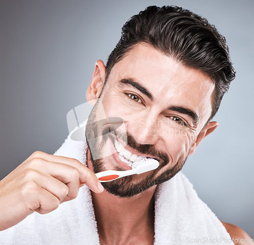 Image of Brushing teeth, studio portrait and man with toothbrush, dental wellness and healthy mouth care. Happy face, male model and oral cleaning for fresh breath, smile and facial happiness with toothpaste