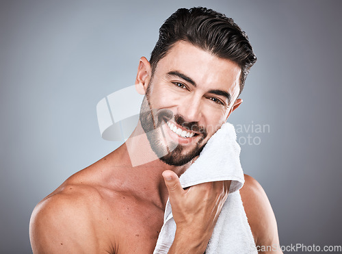 Image of Skincare, wellness and portrait of a happy man in a studio with a self care, natural and face routine. Health, dermatology and male model with a facial towel for treatment isolated by gray background