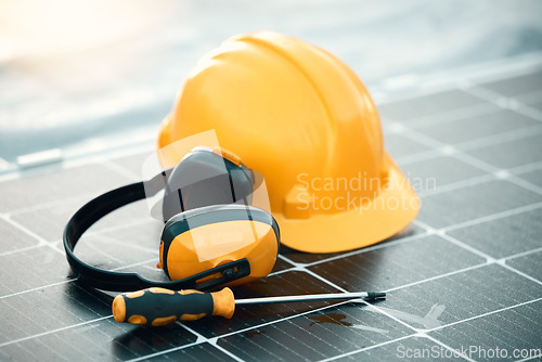 Image of Solar panel maintenance, tools and outdoor by helmet, headphones or renewable energy by blurred background. Photovoltaic tech goals, sustainability vision and eco friendly electricity by screwdriver