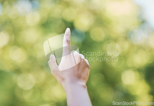 Image of Hand, index finger and pointing in nature, outdoors or at park at something. Direction, bokeh and hands point up for gesture, signal or sign language, counting fingers or emoji, mathematics or timer.