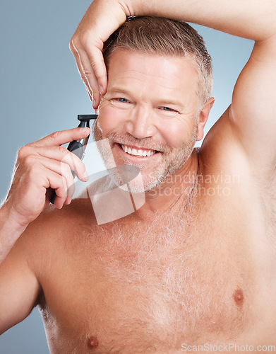 Image of Cleaning, razor and portrait of man with beard for wellness, healthy skin and hygiene on blue background. Barber aesthetic, skincare and face of male with shaver for facial, hair care and grooming