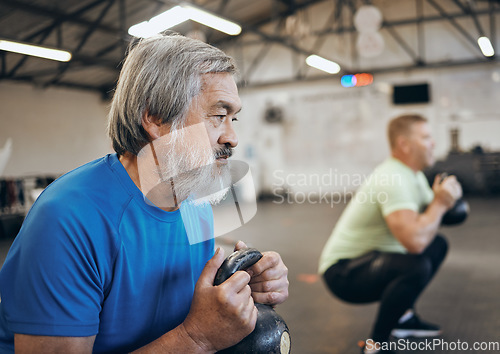 Image of Fitness, senior and man workout with personal trainer at the gym squat with kettlebell equipment for strength. Elderly, old and training people exercise in a sports club for wellness and health