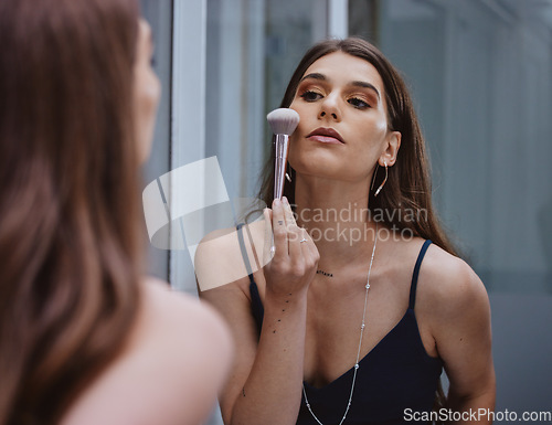 Image of Woman with makeup brush, cosmetic application in mirror and getting ready at home in Los Angeles. Apply luxury beauty product in reflection, face of gen z model and creative aesthetic on skin