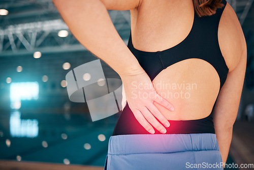 Image of Spine pain, swimmer and woman by a pool with injury from exercise, workout and swim race. Back inflammation, muscle and backache of a young athlete with a swimming sports accident of training