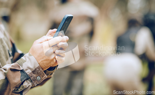 Image of Soldier, hands and phone texting in communication for social media, networking or conversation at war. Hand of person holding mobile smartphone on app in the army for discussion, chatting or contact