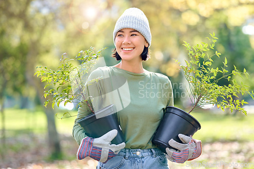 Image of Plants, gardening and woman volunteering for agriculture, growth project and sustainability on earth day. Park, natural environment and community service worker, farmer or person with trees in forest