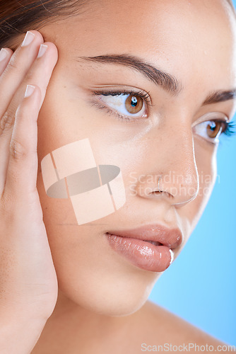 Image of Skincare, face and woman in studio for beauty, wellness and cosmetics grooming on blue background. Skin, facial and girl model relax in luxury, collagen and dermatology, self care or hygiene isolated