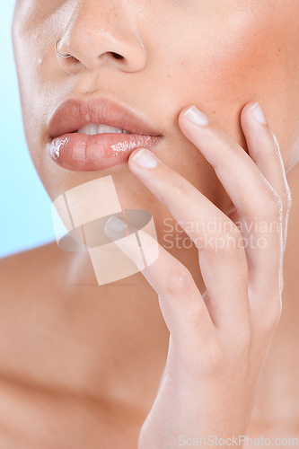 Image of Skincare, beauty and mouth of woman with hands on blue background for wellness, cosmetics and makeup. Dermatology, luxury spa and face zoom of girl for facial treatment, glowing and healthy skin
