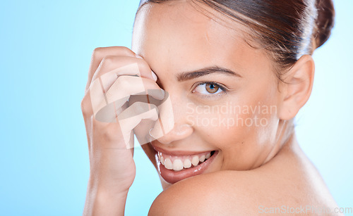 Image of Portrait, skincare and woman in studio for beauty, wellness and cosmetics grooming on blue background. Face, skin and girl model relax in luxury, facial and dermatology, self care or hygiene isolated