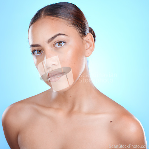 Image of Portrait, beauty and blue background with a model black woman in studio for skincare or wellness. Face, skin and makeup with an attractive young female posing for natural treatment or cosmetics