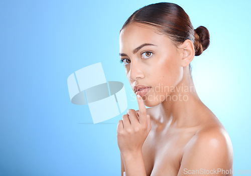 Image of Portrait, beauty and mock up with a model black woman in studio on a blue background for skincare. Face, skin and mockup with an attractive young female posing for natural treatment or cosmetics