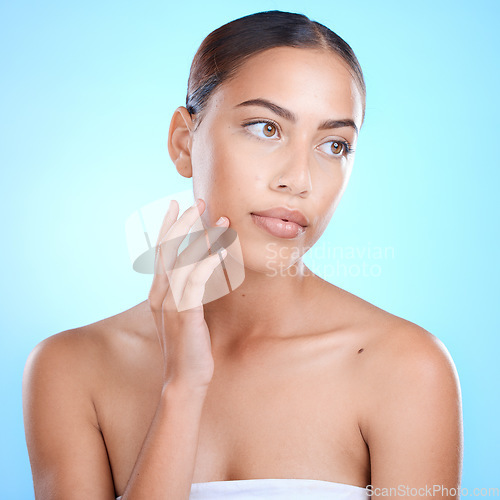 Image of Skincare, beauty and woman in a studio with a natural, wellness and cosmetic facial treatment. Health, cosmetics and female model from Brazil with a face or skin routine isolated by a blue background
