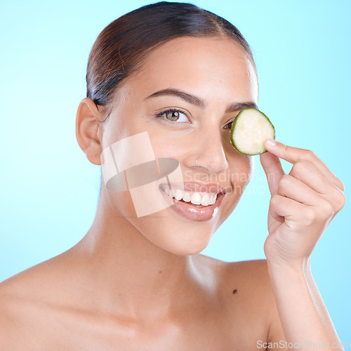 Image of Skincare, cucumber and beauty portrait of woman about natural dermatology face cosmetics. Happy person with vegetable spa product for self care, skin glow and facial wellness on blue background