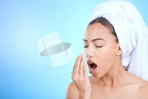 Image of Shower, grooming and woman smelling breath for oral care isolated on blue background in a studio. Dental, healthcare and girl breathing into hand to check for odor problem on a mockup space backdrop