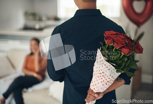 Image of Man, hands and red roses behind back for valentines day surprise, gift or present to celebrate date at home. Hand of male with bouquet of flowers in celebration anniversary for special month of love