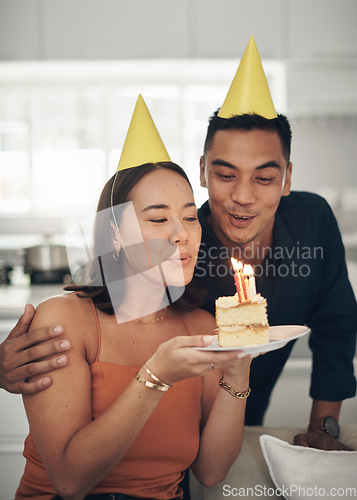 Image of Birthday, party and couple with candles on cake enjoying celebration, special day and anniversary together. Love, dating and man and woman blow flame on dessert, sweet treat and celebrate happiness