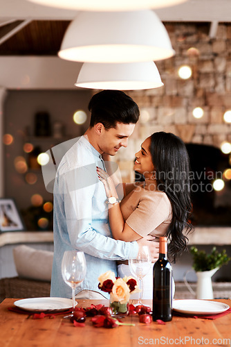 Image of Love, smile and romance, couple hug on valentines day date at home with wine, rose petals and bokeh. Date night, man and woman in living room, valentine celebration and happy relationship together.