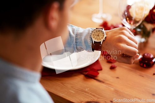 Image of Man checking watch, time on date at dinner table and waiting for person at a restaurant reservation. Impatient guy alone at coffee shop, stress of modern dating and closeup of looking at wristwatch