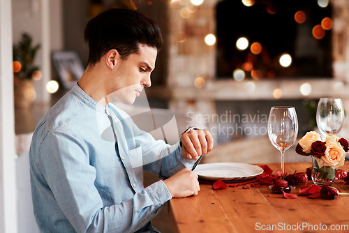 Image of Date, watch and man waiting while in the restaurant for valentines day checking the time. Fine dining, late and upset guy by the table for a dinner reservation for anniversary or romantic event.