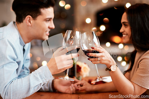 Image of Couple holding hands at table, love and cheers with wine on valentines day date at home with smile and bokeh. Date night, man and woman in living room, valentine celebration and happy relationship.