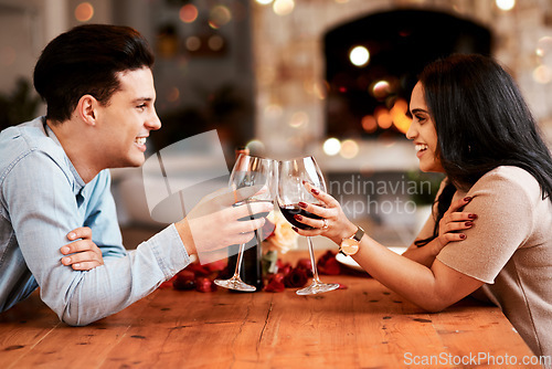 Image of Love, wine and couple cheers on valentines day date at home with smile, romance and bokeh. Date night, man and woman at table in living room, valentine celebration and happy relationship together.