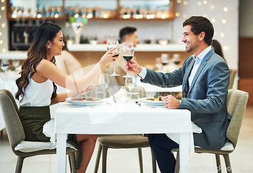 Image of Love, wine and couple toast in restaurant for romantic dinner, honeymoon and anniversary celebration. Valentines day, fine dining and man and woman together for luxury date, alcohol drinks and relax