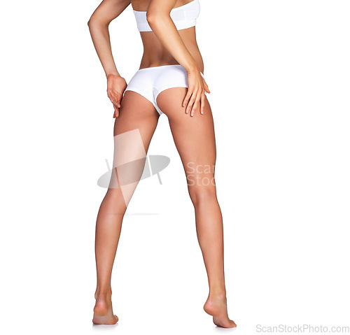 Image of Buttocks, legs and underwear with a model woman in studio isolated on a white background for skincare. Bum, panties and body with a female standing on blank mockup space to promote fitness or health