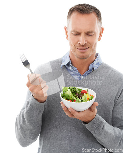 Image of Diet, nutrition and unhappy man with salad and fork disappointed with healthy lunch or dinner in studio. Health, wellness and food, model with frown and nutritional meal isolated on white background.