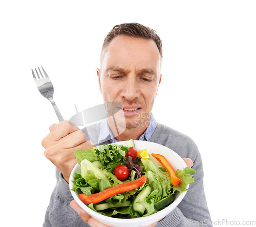 Image of Man with salad, frown on face and vegetables, problem with healthy lifestyle and diet isolated on white background. Health, wellness and male with doubt about food choice, nutrition in studio