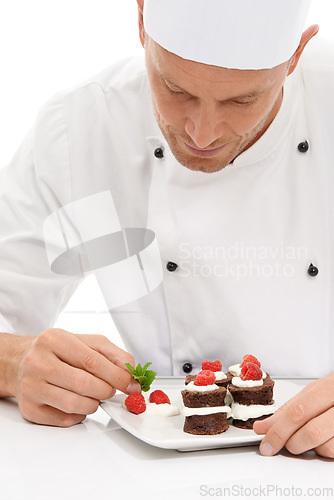 Image of Cook, dessert and mint on sweet chocolate or berries on food by culinary chef with recipe on a plate in white studio background. Cooking, presentation and man or person making mini cakes as cuisine