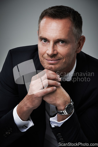 Image of Portrait, man and in suit with smile, leadership and confident guy on grey studio background. Face, male leader and entrepreneur with elegance, glamour and management with happiness or corporate deal