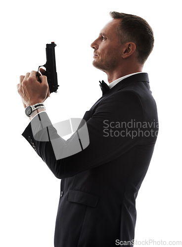 Image of Spy man, profile and gun with suit for undercover mission, justice or espionage by white background. Government agent, detective and weapon in studio with designer tuxedo, secret information and work