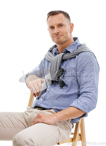 Image of Portrait, fashion and man with style sitting on a chair and confident person isolated in a studio white background. Trendy, gentleman and guy or model looking handsome, stylish and well dressed