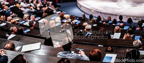 Image of Business and entrepreneurship symposium. Audience in conference hall. Rear view of unrecognized participant in audience.