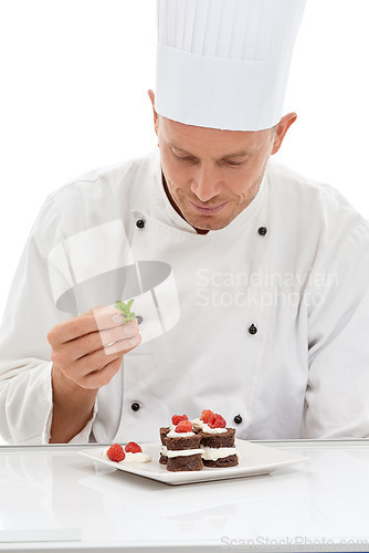 Image of Chef, presentation and mint on sweet cuisine by culinary cook with chocolate recipe on a plate isolated in white studio background. Cooking, food and man or person making mini cakes in a kitchen