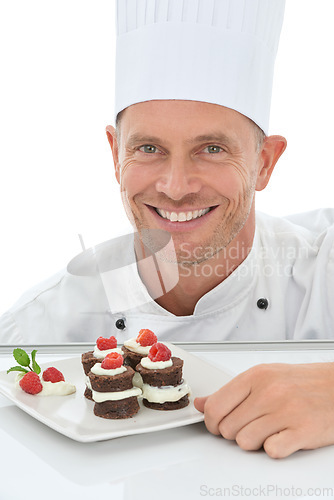 Image of Man, face and chef, dessert in portrait and smile, baker skill and cake presentation isolated on white background. Happy person, chocolate and fruit for Valentines day plate and hospitality in studio