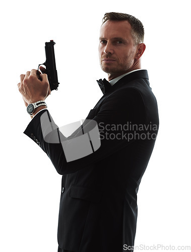 Image of Spy man, portrait and gun with suit for undercover mission, justice or espionage by white background. Government agent, detective and weapon in studio with designer tuxedo, secret information and job