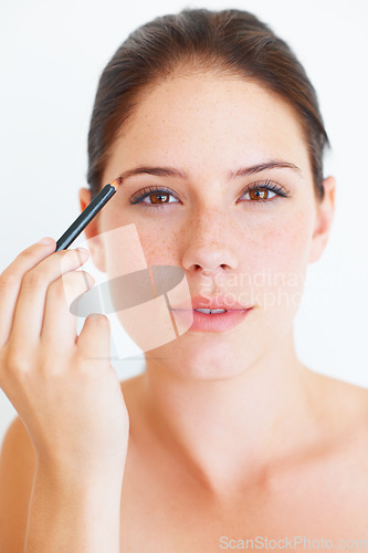 Image of Beauty, makeup and portrait of woman with eyebrow pencil in studio for shape or grooming on white background. Face, brow and girl model with microblading tool for drawing, filling or product isolated